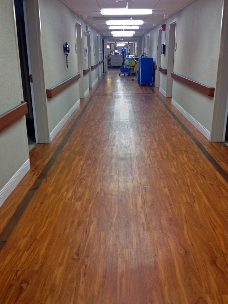 Vinyl plank with borders in Nursing & Rehab hallway